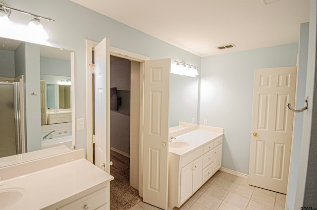 bathroom with vanity, tile patterned flooring, and a shower with door