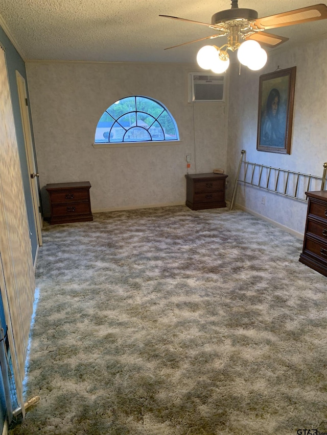 spare room with carpet floors, a wall mounted AC, a ceiling fan, and a textured ceiling