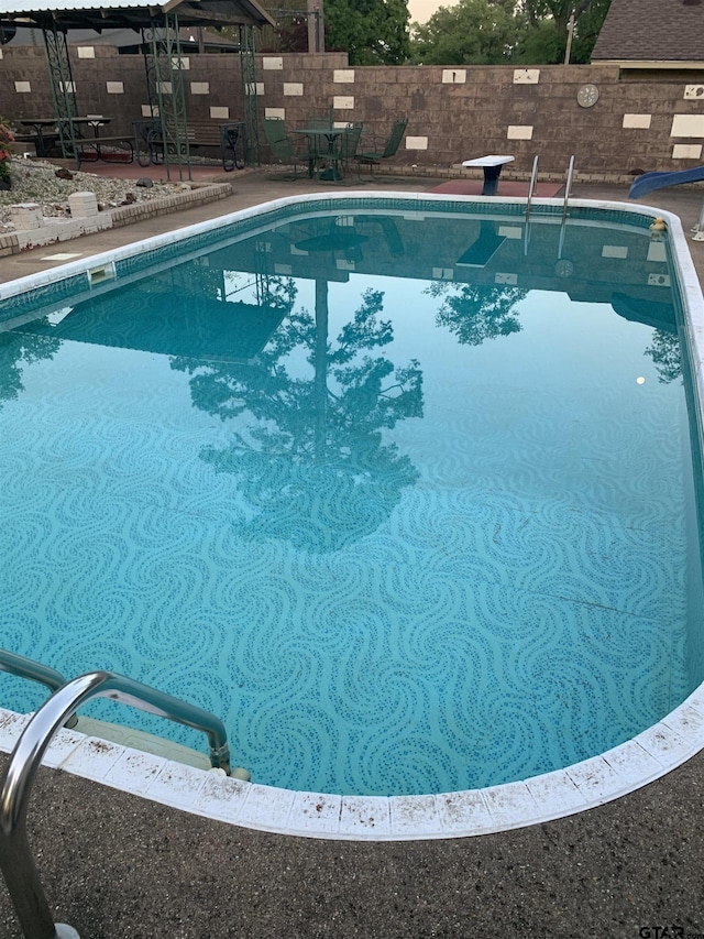 view of swimming pool featuring a patio, a gazebo, a fenced in pool, and fence