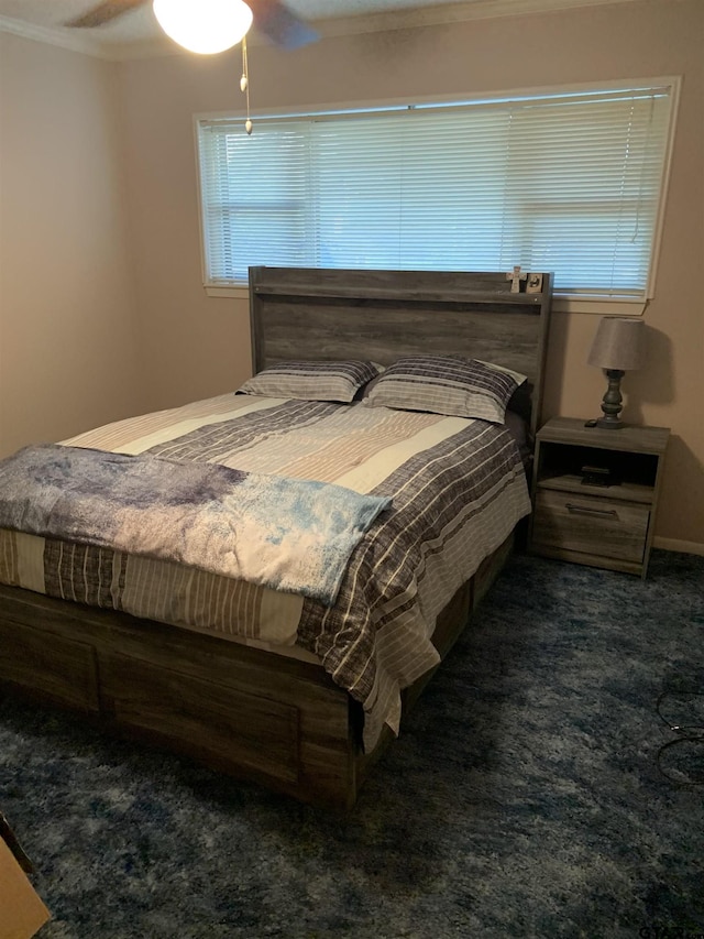 bedroom with ceiling fan and ornamental molding