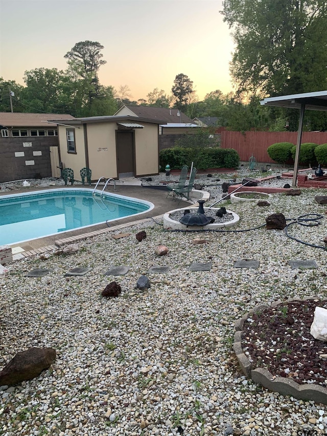 pool at dusk featuring a fenced in pool, a patio area, and fence