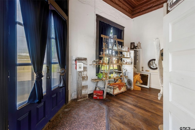 entryway featuring wood-type flooring and ornamental molding