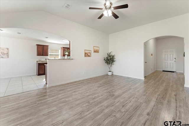 unfurnished living room with ceiling fan and light wood-type flooring