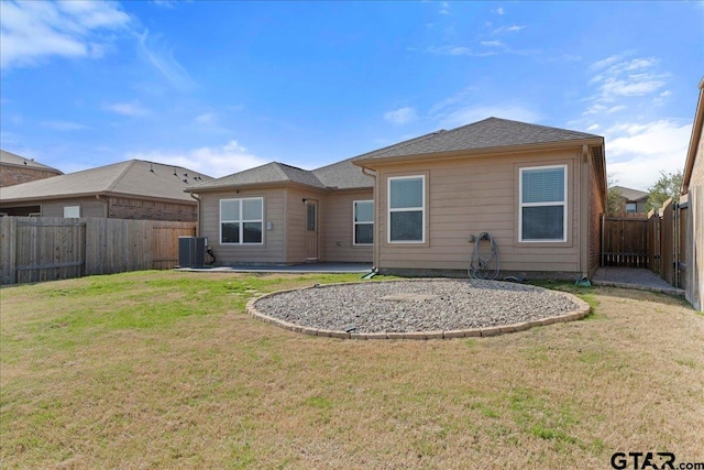 rear view of property featuring central AC unit, a lawn, and a patio