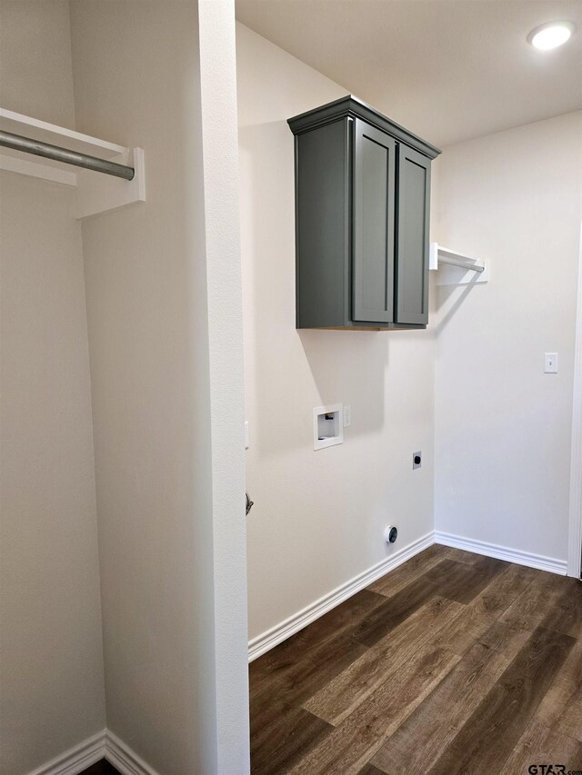 laundry room featuring electric dryer hookup, washer hookup, dark wood finished floors, and baseboards