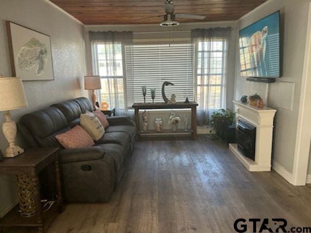 living area with a wealth of natural light, wood finished floors, and wood ceiling