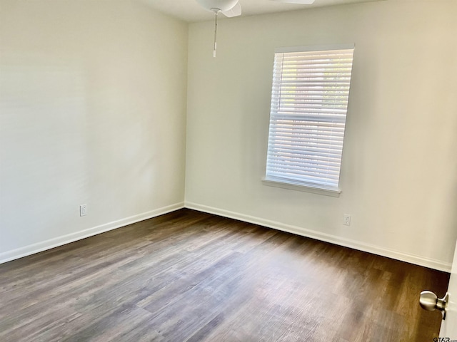 unfurnished room featuring ceiling fan and dark hardwood / wood-style flooring