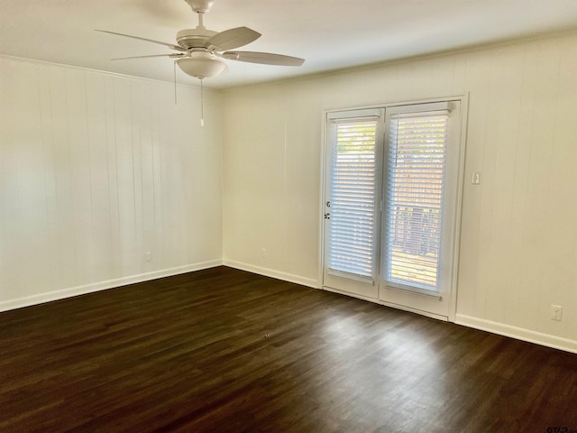 unfurnished room featuring ceiling fan and dark hardwood / wood-style floors