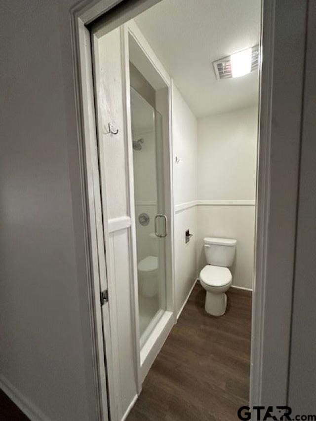 bathroom with hardwood / wood-style floors and toilet