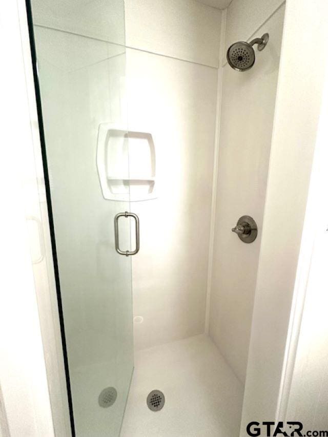 bathroom with a shower with shower door