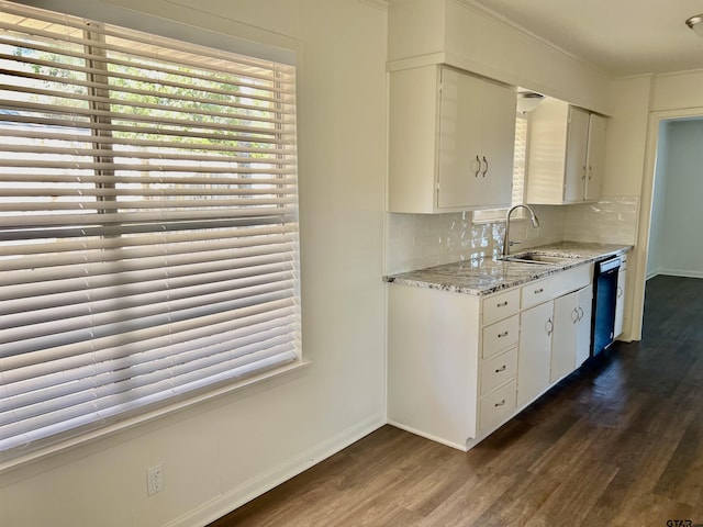 kitchen with white cabinets, backsplash, sink, and black dishwasher