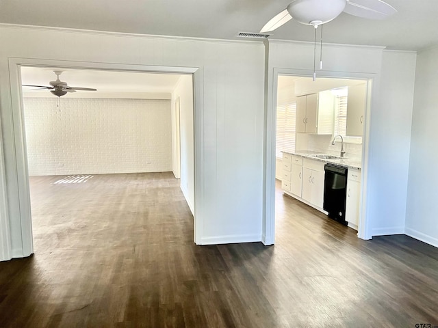 hall featuring dark wood-type flooring, sink, and ornamental molding