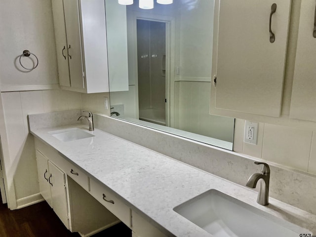 bathroom with vanity, backsplash, and hardwood / wood-style flooring