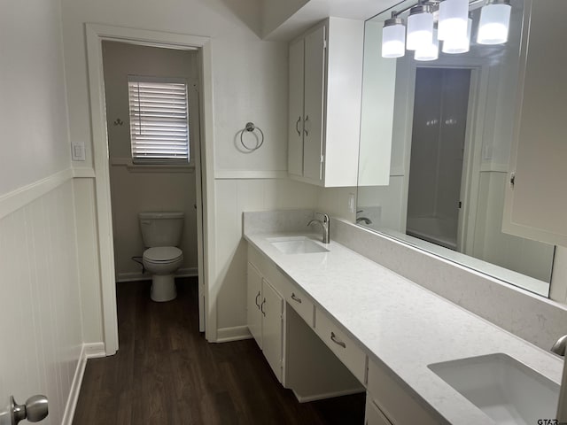 bathroom with hardwood / wood-style floors, toilet, and vanity