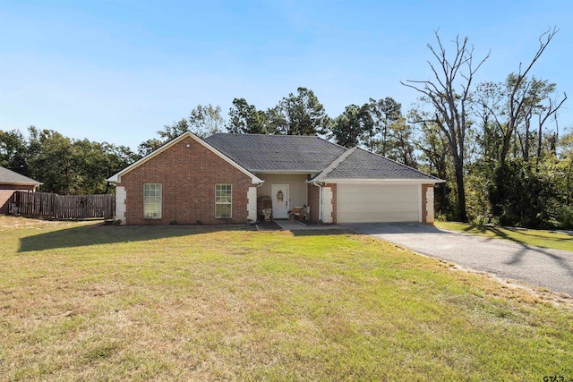 ranch-style house with a garage and a front lawn