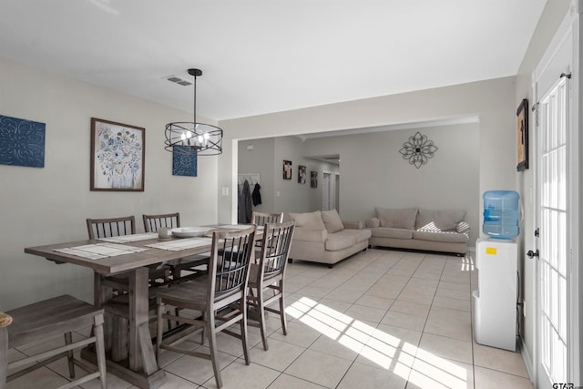 dining room featuring an inviting chandelier and light tile patterned flooring