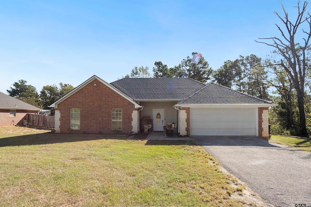 ranch-style home featuring a garage and a front lawn