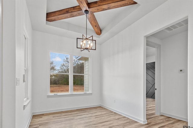 unfurnished dining area with beam ceiling, a chandelier, and light hardwood / wood-style floors