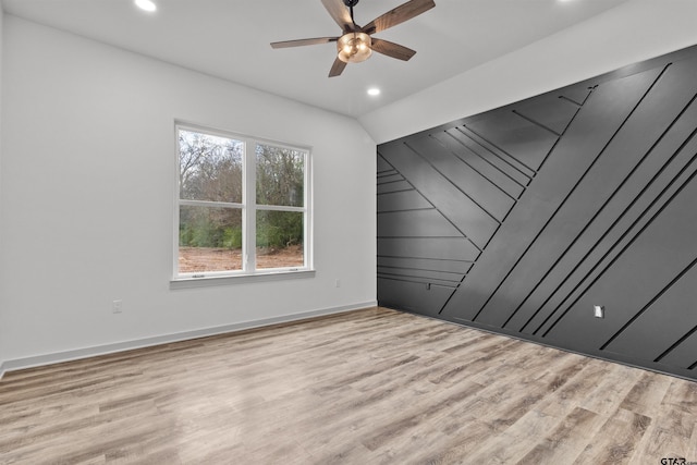 empty room with ceiling fan and light wood-type flooring