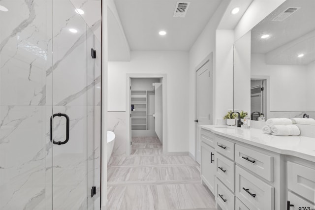 bathroom featuring vanity and a shower with door