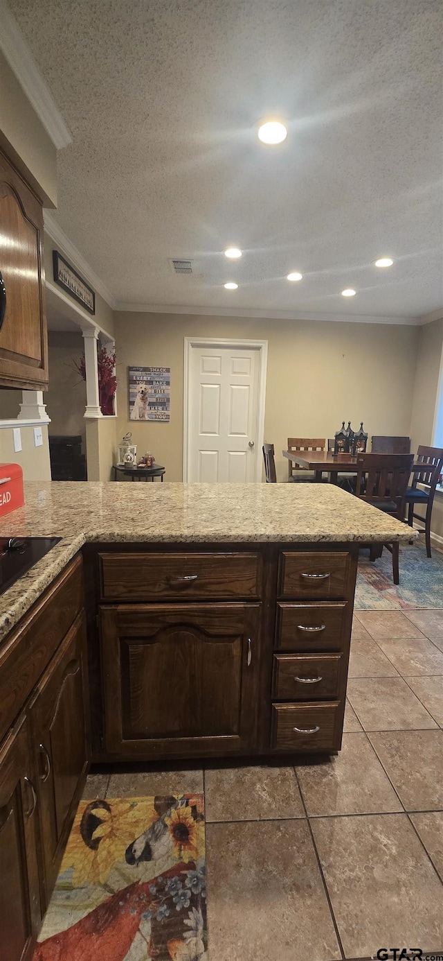 406 Brookwood Dr, Mount Pleasant, TX 75455 - kitchen featuring a textured ceiling, light stone countertops, recessed lighting, light tile patterned flooring, and black electric stovetop