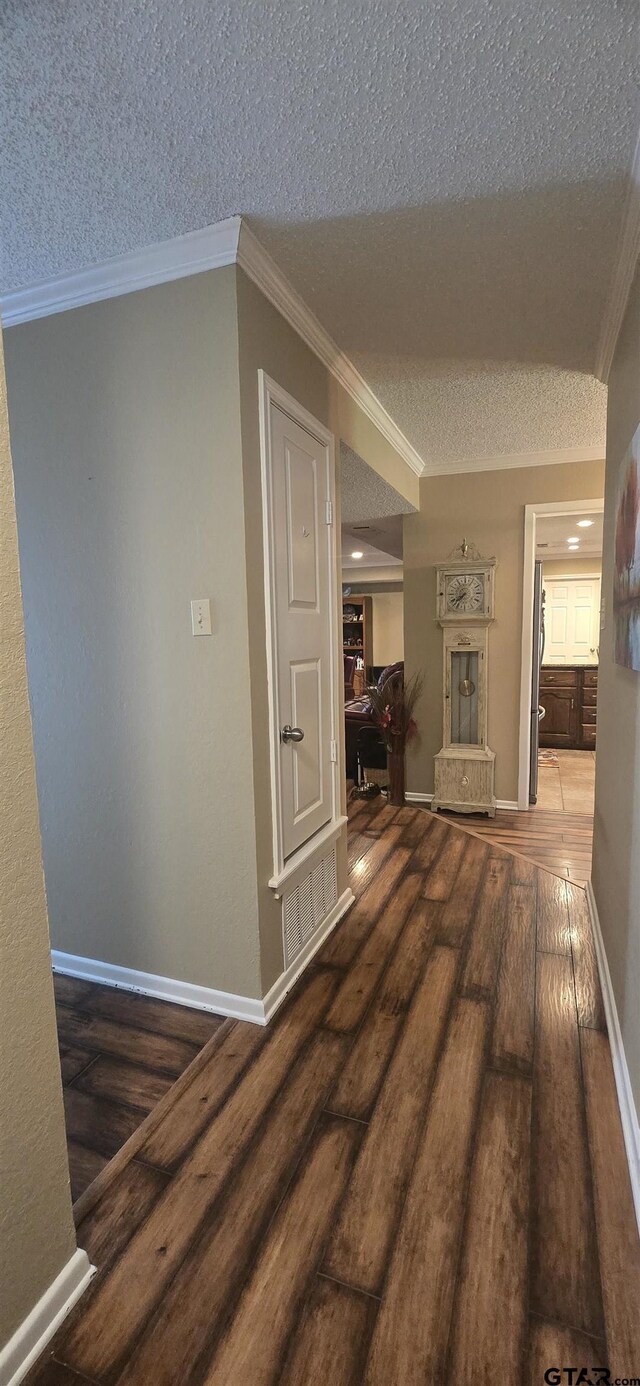 406 Brookwood Dr, Mount Pleasant, TX 75455 - hall featuring wood-type flooring, a textured ceiling, and ornamental molding