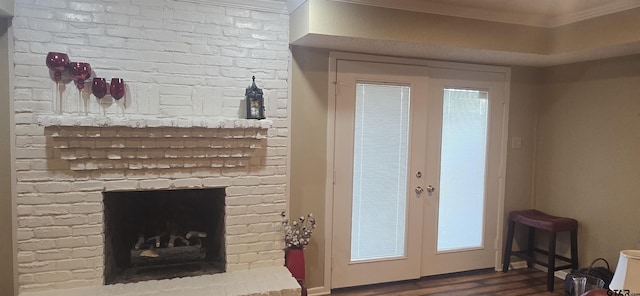 406 Brookwood Dr, Mount Pleasant, TX 75455 - living area with ornamental molding, dark wood finished floors, french doors, and a brick fireplace