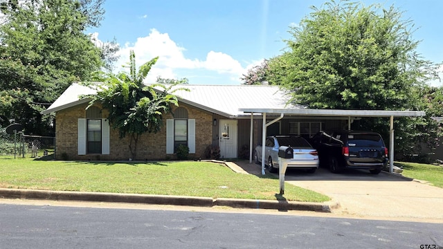 1516 Bowie Dr, Tyler, TX 75701 - ranch-style home featuring driveway, brick siding, a metal roof, and a carport