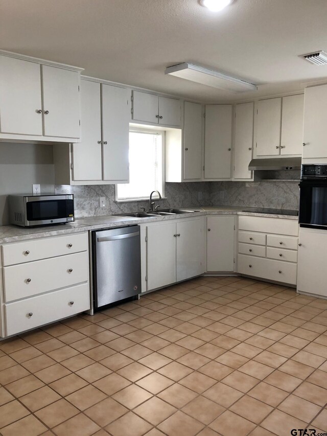 1516 Bowie Dr, Tyler, TX 75701 - kitchen featuring black appliances, backsplash, light countertops, and white cabinetry