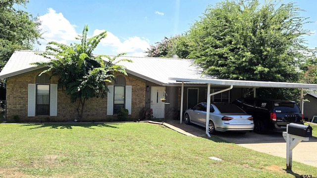 1516 Bowie Dr, Tyler, TX 75701 - ranch-style house with a front lawn, a metal roof, driveway, and brick siding