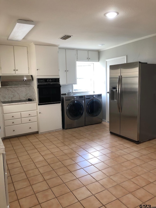 1516 Bowie Dr, Tyler, TX 75701 - laundry room featuring washer and dryer and light tile patterned floors