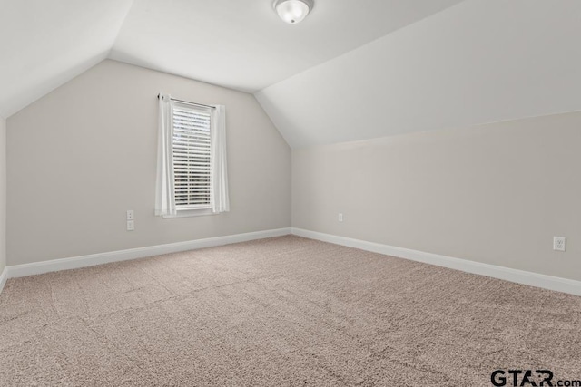 bonus room featuring carpet floors and lofted ceiling