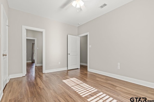 unfurnished bedroom featuring ceiling fan and hardwood / wood-style floors