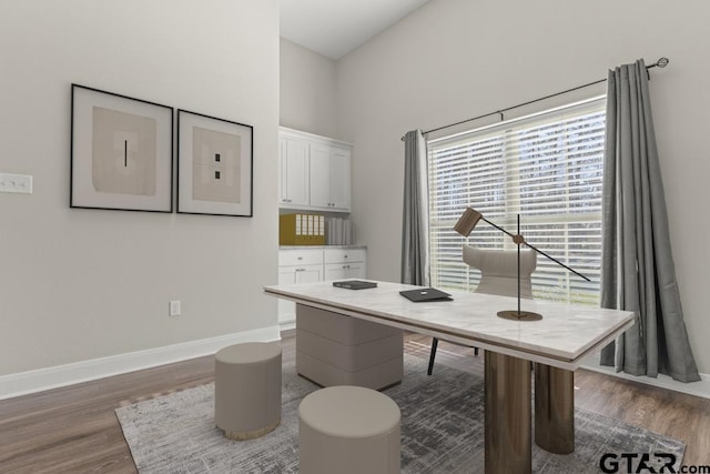 office area featuring a high ceiling and dark hardwood / wood-style floors