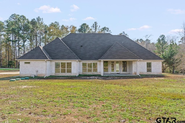 view of front of house with french doors and a front lawn