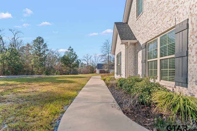 view of property exterior with a yard