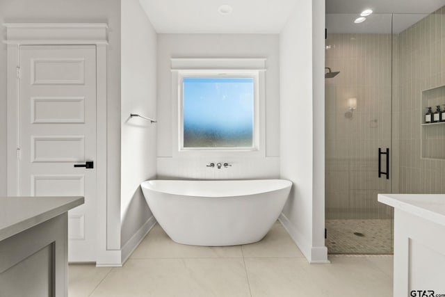 bathroom featuring tile patterned floors, vanity, and plus walk in shower