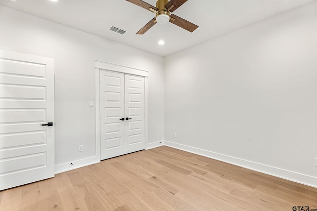 unfurnished bedroom with a closet, ceiling fan, and light wood-type flooring