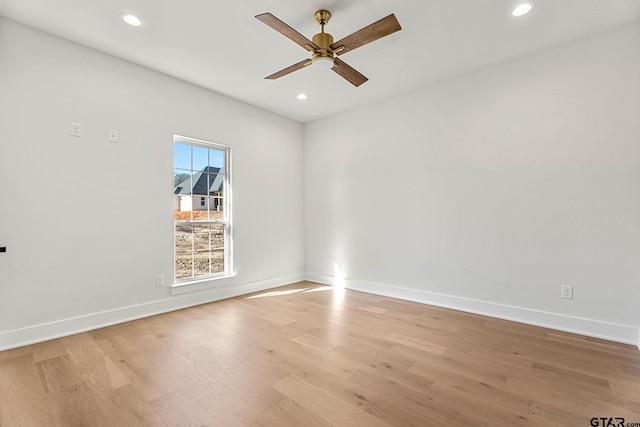 empty room featuring ceiling fan and light hardwood / wood-style flooring