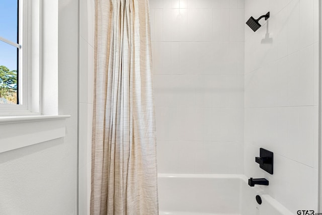 bathroom featuring shower / tub combo with curtain