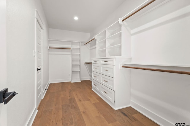 spacious closet featuring light hardwood / wood-style floors