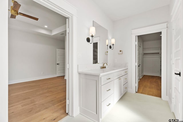 bathroom with ceiling fan, vanity, and hardwood / wood-style floors