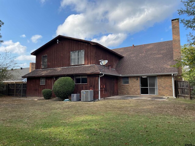 rear view of property with a patio, a lawn, and cooling unit