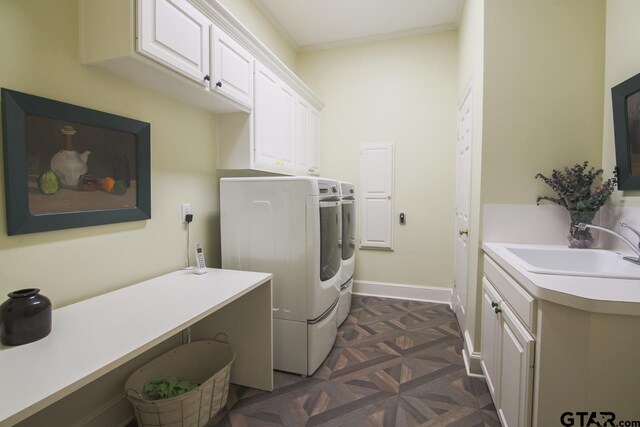 laundry area featuring cabinets, dark parquet floors, sink, washer and dryer, and ornamental molding