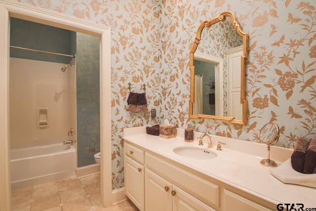 bathroom with bathtub / shower combination, toilet, vanity, tile patterned flooring, and wallpapered walls