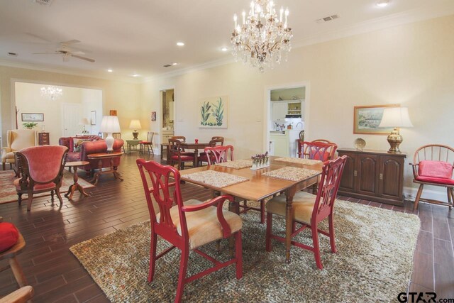 dining area featuring ceiling fan with notable chandelier and ornamental molding