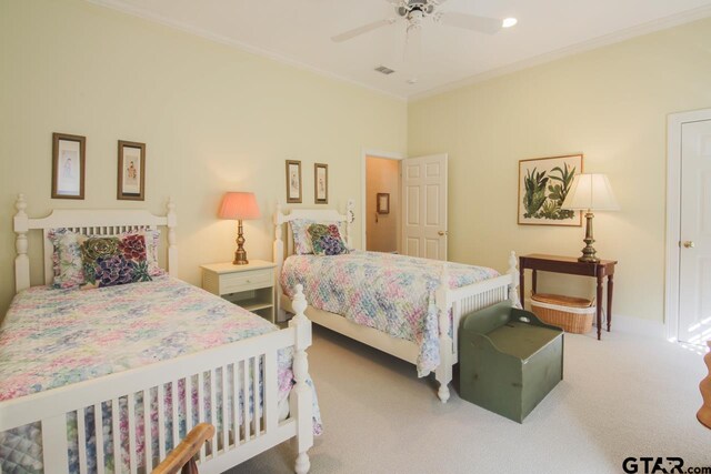 carpeted bedroom with ornamental molding, visible vents, ceiling fan, and baseboards