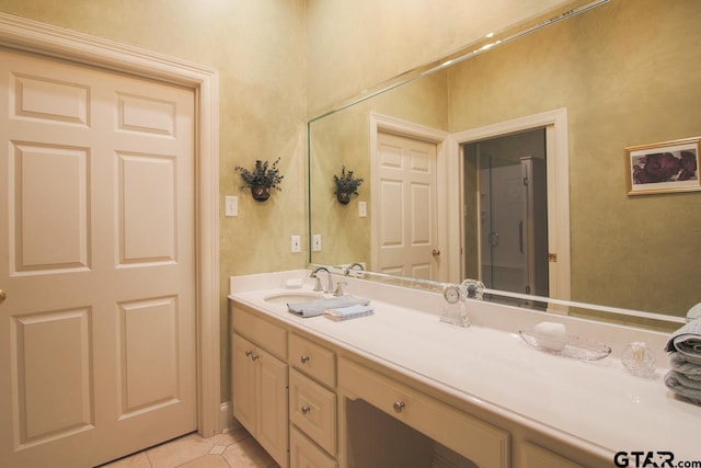 bathroom with tile patterned flooring and vanity