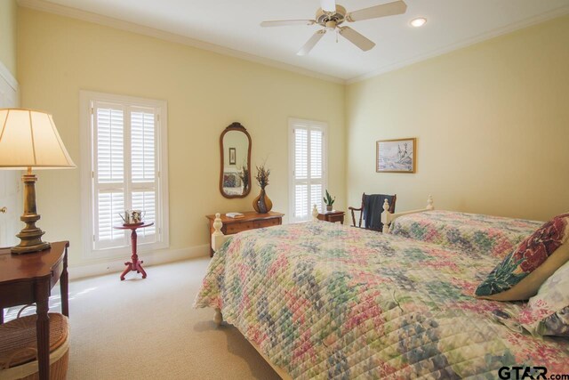 bedroom with ceiling fan, crown molding, and light carpet