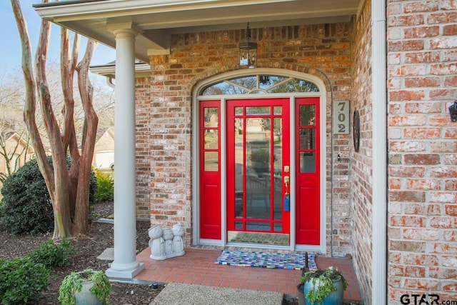 doorway to property with brick siding